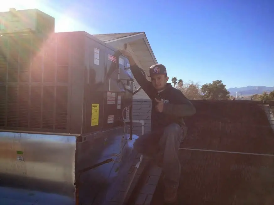 HVAC technician performing Boiler Repair on a rooftop unit in Horseshoe Bay